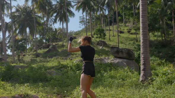 Healthy Young Woman Athlete During Boxing Workout Outside Training Self Defence Using Hands and Legs