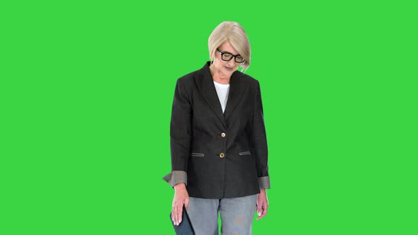 Elderly Fashionable Woman in a Suit Walking on a Green Screen Chroma Key