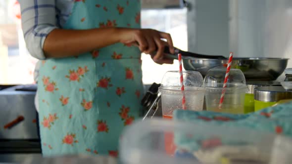 Waitress working at counter of food truck