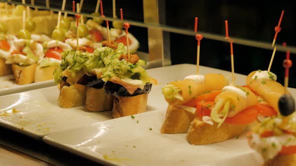 Showcase Window Display Assortiment with Tapas – Traditional Spanish Sandwiches Starters in a Cafe