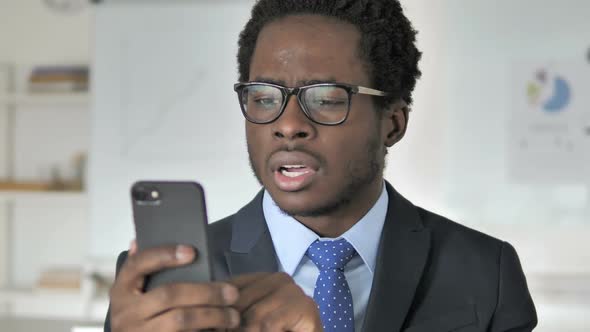 African Businessman Upset By Loss on Smartphone