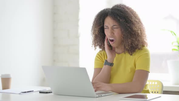 African Woman having Toothache at Work