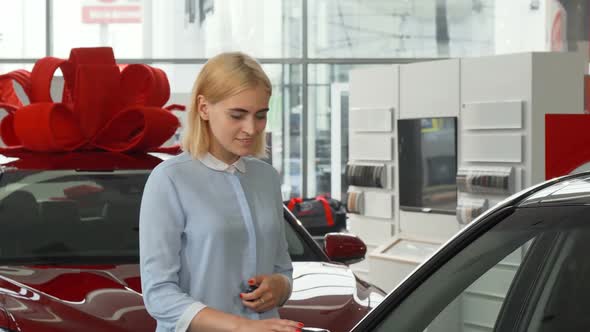 Cheerful Beautiful Young Woman Showing Keys To Her New Car