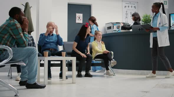 Mother with Little Girl Leaving Waiting Room Lobby to Attend Consultation