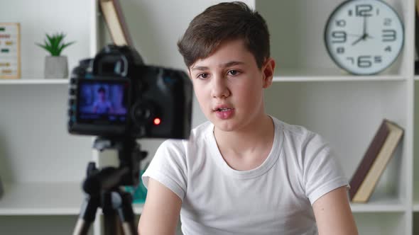 Boy Videoblogger Filming New Vlog Video with Professional Camera at Home