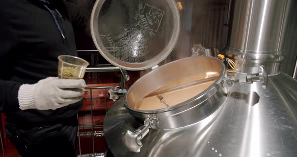 Beer Production Pouring Malt Grains Into The Large Milling Tank In The Brewery