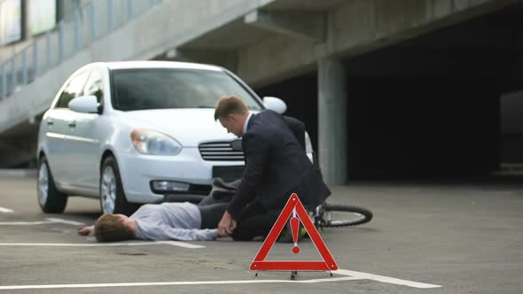 Red Triangle on Road, Male Calling Emergency After Car Accident With Bicycle