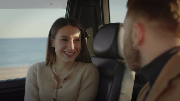 Engaged couple are cuddling in the car