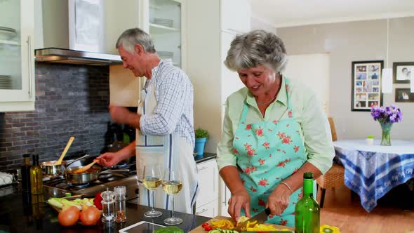 Senior couple tasting food cooking in kitchen 4k