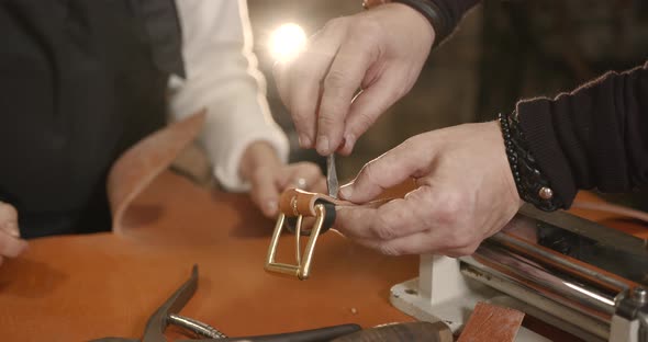 Master Making Leather Belt in a Workshop