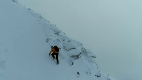 Mountain Climber on a Steep Snowy Ascent