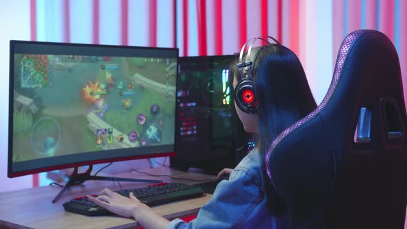 Young Asian Girl Gamer Playing Online Video Game