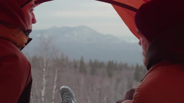 Couple Talking in Tent on Top of Mountain