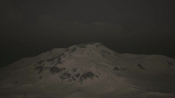 Dramatic Dark Rocky Mountain with Patches of Snow in Storm alt