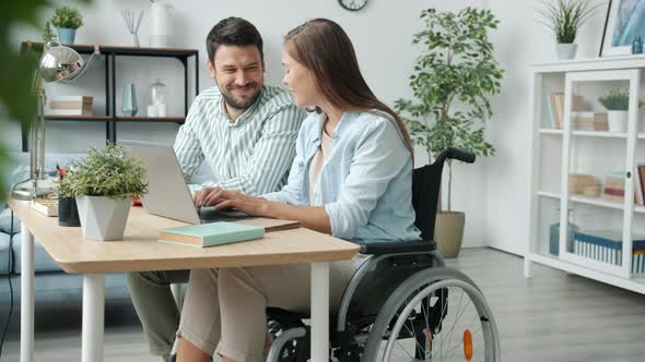 Handicapped Woman Talking to Husband Using Laptop Then Getting Good News Hugging Laughing