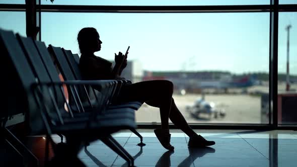 Female Passenger in Waiting Area of Airport, Wait for Flight, Surfing Internet