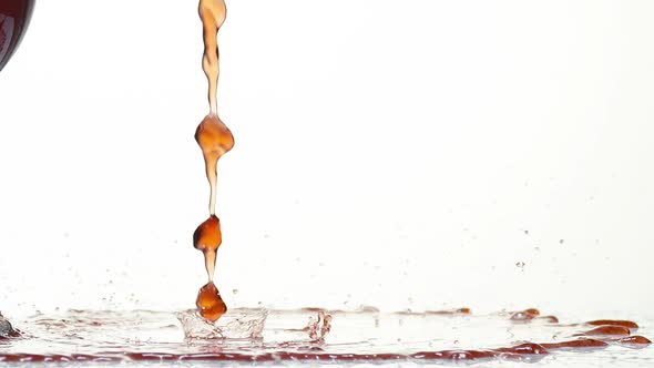 980018 Red Wine being poured near Glass, against White Background, Slow motion