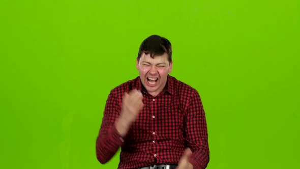 Young Guy Is Happy with His Victories, He Is Happy. Green Screen
