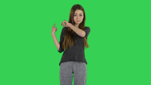 Cute Brunette with Long Hair Is Telling a Lot of Interesting Information on a Green Screen