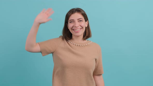 Friendly Beautiful Woman Saying Hi and Smiling Welcoming Friends with Hand