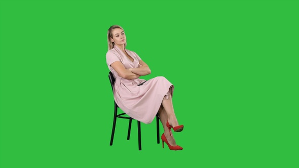 Woman in Pink Dress Sitting on A Chair Waiting for Someone