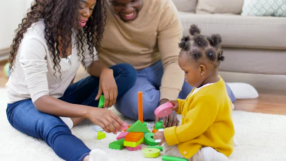 African Family Playing with Baby Daughter at Home