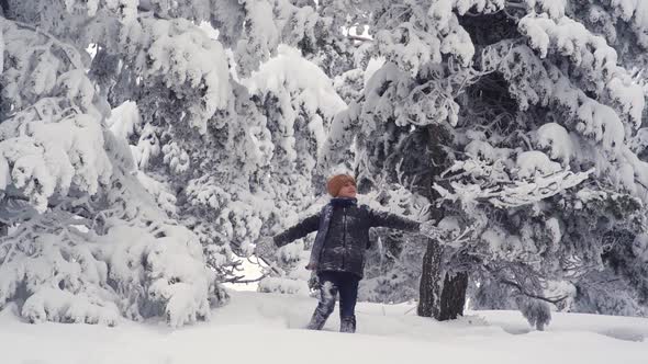 Boy looking at the sky in snowy weather.