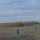 Aerial View of Horseback Riding in a Field at Sunset. - VideoHive Item for Sale