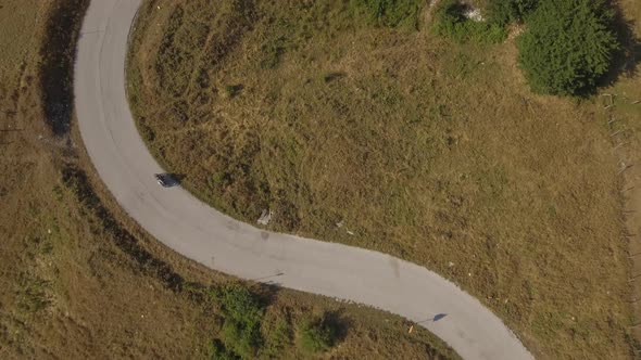 Aerial view of a man driving a motorbike on a mountain road