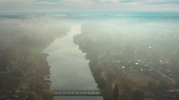 Beautiful morning, summer flight over the river, The bridge over the river in the fog, at dawn