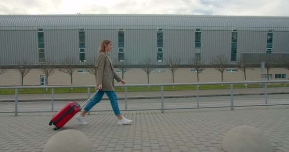 A Young Girl Hurries To the Plane with a Suitcase. Travel By Plane. Sunny Weather. 