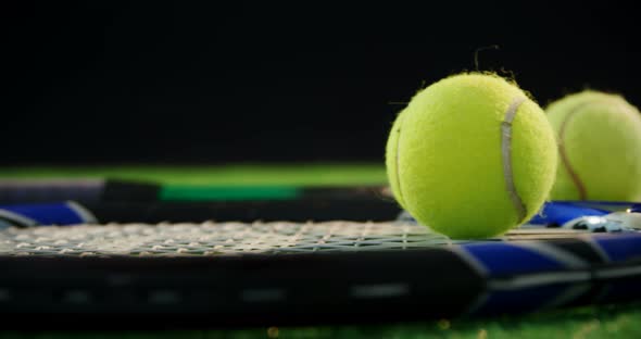 Tennis balls and racket in court 4k