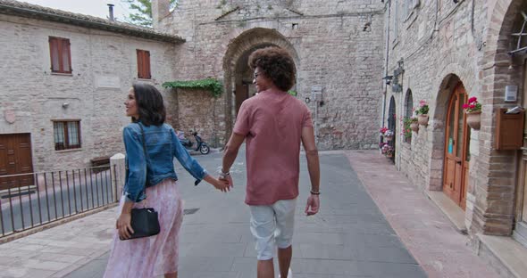 Romantic Couple Walking Visiting Rural Town of Assisi.Back follow. Friends Italian Trip in Umbria
