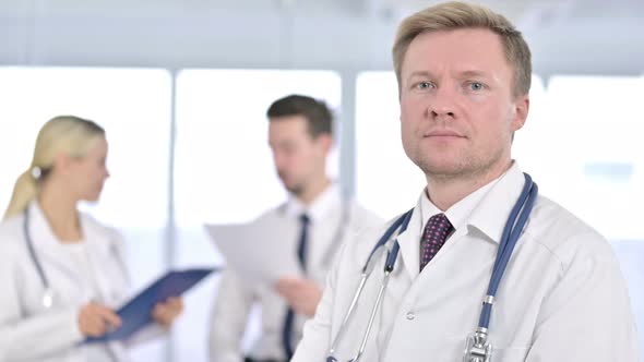 Portrait of Serious Male Doctor Saying No By Finger Sign 