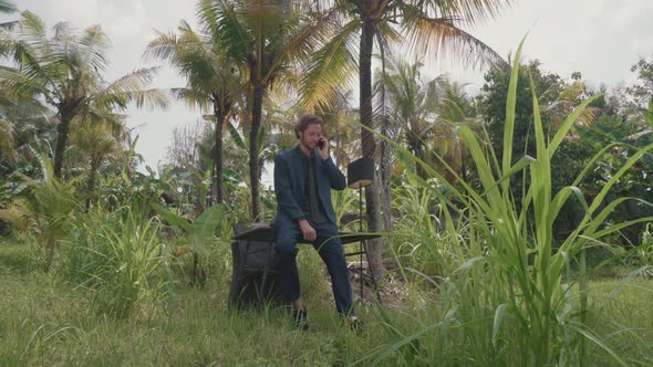 Man Talking On Phone Outside In Bali