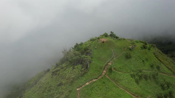 Aerial landscape view of greenery rainforest mountains on foggy day by drone