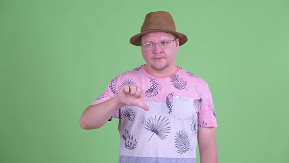 Angry Overweight Bearded Tourist Man Giving Thumbs Down