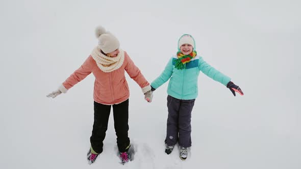 Mom and Daughter Have Fun in the Winter - Fall on Pure Snow