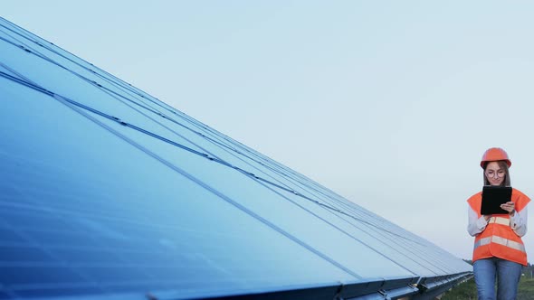 Inspector Engineer Woman Holding Digital Tablet Working in Solar Panels Power Farm