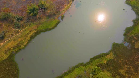 Aerial Over Lake At Grounds Of Janhangirnagar On Sunny Day. Dolly Back