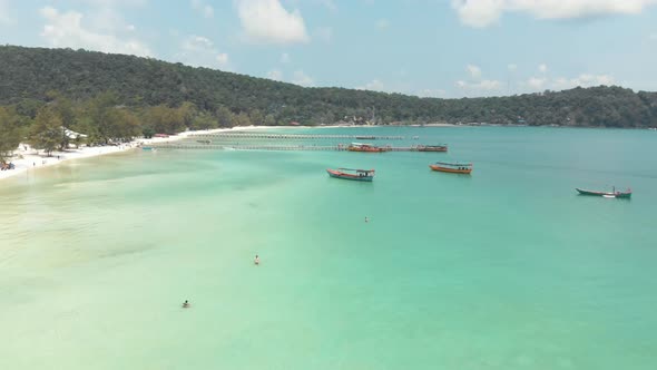 Beautiful Turquoise Blue shallow shore extending along the coast with fishing boats moored