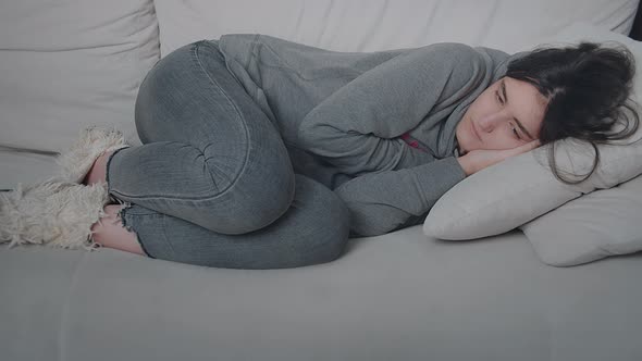 Tired Teen Girl Lay Down on Sofa Vacation Concept