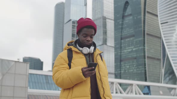 African Man Using Smartphone Outdoors