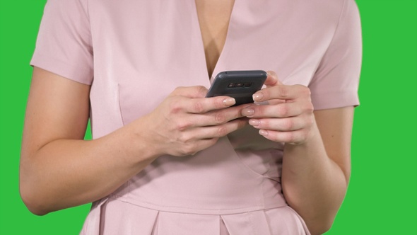 Woman Hand Using a Smart Phone on A Green Screen, Chroma Key