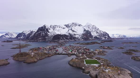 Henningsvaer Village and Mountains in Winter. Lofoten, Norway. Aerial View