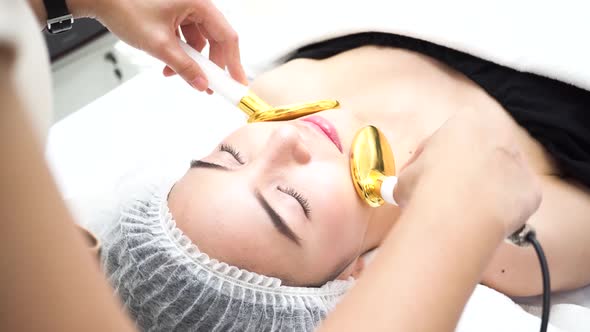 Asian Woman Getting Beauty Device on Face at Beauty Clinic