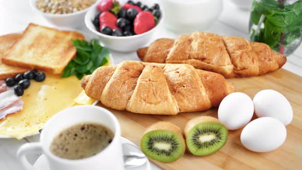 Appetizing Fresh Bakery Croissant on Table Setting Ready for Healthy Breakfast Zoom in