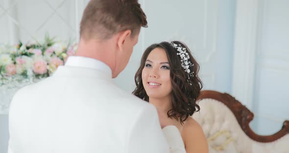 Bride and Groom Kiss Each Other Wedding Couple Indoors Beautiful Model Girl in White Dress Man in