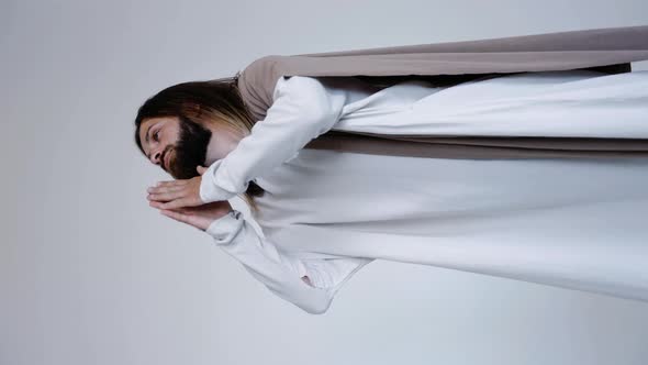 Jesus Prays with His Hands Together on a White Background