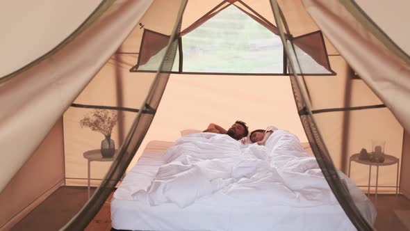 Couple Sleeping in Bed in Glamping